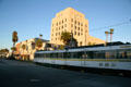 Los Angeles Metro streetcar passes Long Beach Post Office Building. Long Beach, CA.
