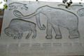 Carved relief of saber tooth tiger, bison & mastodon on facade of Hancock Foundation building at USC. Los Angeles, CA.