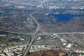 Aerial view of Interchange of San Bernadino, Orange & Chino Valley Freeways beside Puddingstone Reservoir. CA.