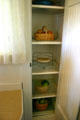 California cooler cupboard in kitchen of Nixon Birthplace where cool air from basement came up through screen shelves. Yorba Linda, CA.