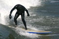 Standing on surf board in Ocean Beach. San Diego, CA