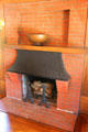 Dining room fireplace with metal canopy at Marston House Museum. San Diego, CA.