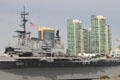 Midway aircraft carrier museum from harbor against city skyline. San Diego, CA.