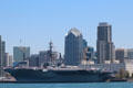 Midway aircraft carrier museum ship against San Diego skyline. San Diego, CA.