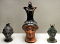 Greek terracotta & bronze oil vessels shaped as female heads at Getty Museum Villa. Malibu, CA.