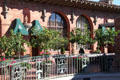 Decorative railings & potted orange trees at Mission Inn. Riverside, CA.