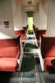 Interior of sleeping car in daytime coach mode with berths closed at Orange Empire Railway Museum. Perris, CA.