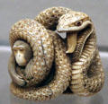 Netsuke of monkey in coils of snake from Japan at Asian Art Museum. San Francisco, CA