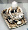 Netsuke of octopus with basket of sea bream, clams, abalone from Japan at Asian Art Museum. San Francisco, CA.