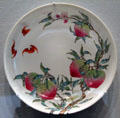 Porcelain plate painted with peaches & bats from China at Asian Art Museum. San Francisco, CA.