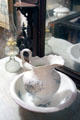 Wash basin, pitcher & glass oil lamp at Mariposa Museum. Mariposa, CA.