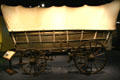 Side of Conestoga prairie schooner with brake handle at Colorado History Museum. Denver, CO.