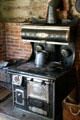 Cast iron Ringen stove from St. Louis in kitchen of settler's log cabin at Clear Creek History Park. Golden, CO.