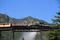 Georgetown Loop Railroad steam locomotive #12 crosses loop bridge against mountain backdrop. Georgetown, CO