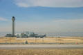 Control Tower against Rocky Mountains at Denver International Airport from runway. Denver, CO.