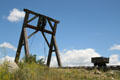 Mine gallows frame for lifting ore from mine shaft, with tracked push cart at South Park City. Fairplay, CO.