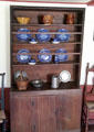 Sideboard with blue-flow plates, brown jugs, & pewter at Strong House. Windsor, CT.