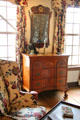 Bedroom with wing chair, chest of drawers & mirror at Silas Deane House. Wethersfield, CT.