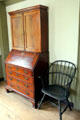 Drop front desk with library case beside Windsor chair at Silas Deane House. Wethersfield, CT.