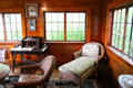 Wicker chaise longue & desk in sunroom at Monte Cristo Cottage. New London, CT.