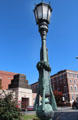 Bronze lampstand supported by sculpted canon & four rifles at Waterbury Soldiers Monument. Waterbury, CT.