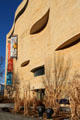Curvilinear limestone facade evokes natural rock formations at National Museum of the American Indian. Washington, DC.