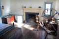 Large bedroom with fireplace & spinning wheel at Old Stone House. Washington, DC.