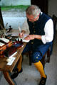 Scribe writes with quill pen at Colonial Spanish Quarter Museum. St Augustine, FL