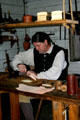Leather craftsman at Colonial Spanish Quarter Museum. St Augustine, FL.
