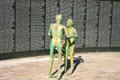 Skeletal statues in front of wall with names of victims at Holocaust Memorial. Miami Beach, FL