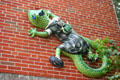 Gecko sculpture dressed in school uniform on side of religious school. Orlando, FL.