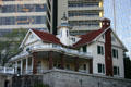 Queen-Anne-style mansion surrounded by highrises overlooking Memorial Arts Building. Atlanta, GA.