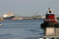 Bulk freighter loads at conveyor belt beside Savannah River harbor facilities. Savannah, GA.
