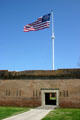 Main gate & star pattern flag at Fort Pulaski Monument. GA.