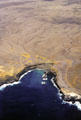 Aerial view of waves meeting desert land. Big Island of Hawaii, HI.