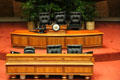 Acacia Koa wood desks of Speaker in House of Representatives chamber of Hawaii State Capitol. Honolulu, HI.