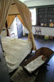 Upstairs bedroom with canopy bed & cradle in Oldest Frame House of Mission House Museum. Honolulu, HI.