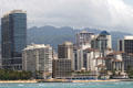 Blue glass Trump International Hotel & Condos set amid surrounding highrises. Waikiki, HI.