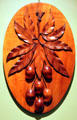 Carved wooden plaque of mangoes by Manuel Silva at Bishop Museum. Honolulu, HI.