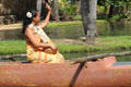 Hawaiian maiden in canoe at Polynesian Cultural Center. Laie, HI.