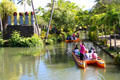 Tourists on canal boats at Polynesian Cultural Center. Laie, HI.