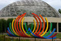 Geodesic dome of Des Moines Botanical Center behind rainbow sculpture of Christiane T. Marteno. Des Moines, IA.