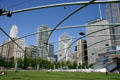 Skyscrapers along Michigan Av. & Randolph St. seen through latticework trellis covering of lawn seating area for Gehry's Pritzker Pavilion in Millennium Park. Chicago, IL.