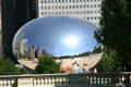 Cloud Gate sculpture in Millennium Park mirrors back Chicago's skyline, visitors & the sun. Chicago, IL.
