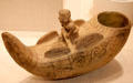 Moche ceramic vessel in form of fisherman in reed boat from North Coast, Peru at Art Institute of Chicago. Chicago, IL.