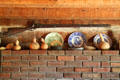 Flintlock, gourds & commemorative plates over fireplace in log cabin visitor center. Vincennes, IN.