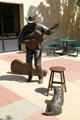 Sculpted man playing guitar by Georgia Gerber in Reflection Square Park on Douglas Street. Wichita, KS.