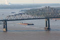 Barge under Interstate Highway 10 bridge on Mississippi River. Baton Rouge, LA.