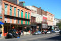 Row of colorful heritage buildings at 907 Decatur St. & up from corner of Dumaine. New Orleans, LA.