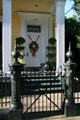 Townhouse with round cast iron gate posts in Garden District. New Orleans, LA.